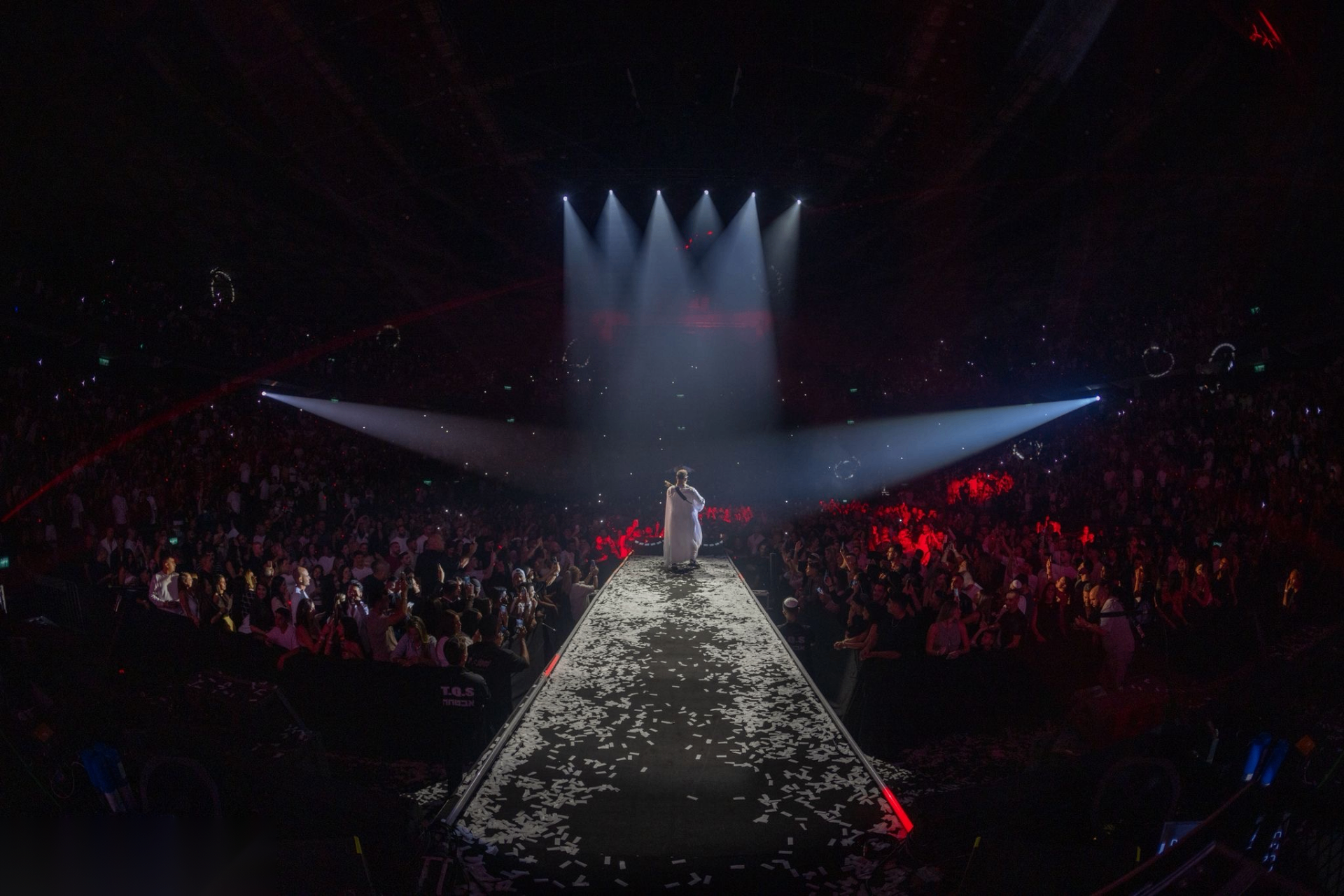 Zehavi on stage in front of a packed arena crowd